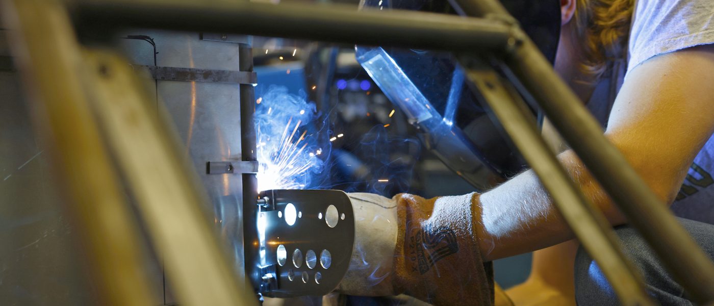 Student welding in the Kulwicki Motorsports Laboratory