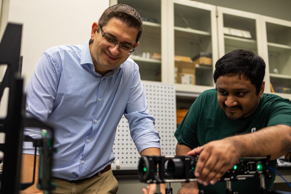 Dr. Falaggis works on research project with student